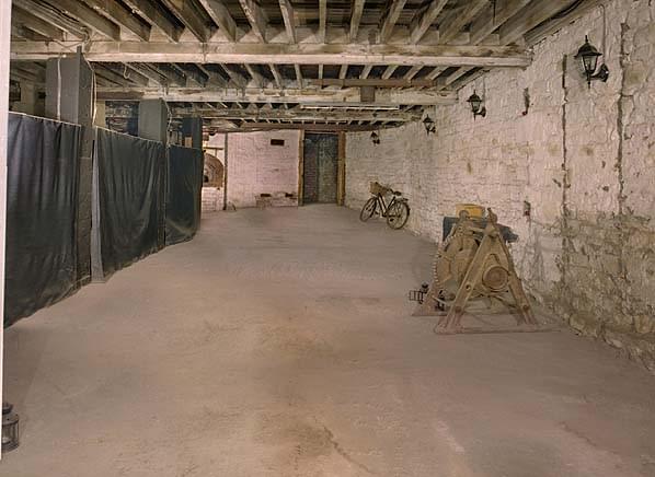 The communal basement area. Note the bread oven on the end wall. The door at the end leads to the underground arcade 