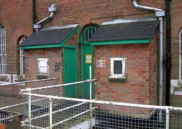 Two toilet blocks either side of a rear entrance to the barrack block. Note the bridge across the gorge (Bob Jenner)