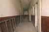 The spine corridor. The rooms on either side have been used as animal pens but this part of the building is now empty (Nick Catford)