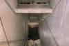 Looking down the main western stairs from the basement to the sub-basement. This photograph was taken in 2001 before the sub-basement was pumped dry. The water can be seen just below the top of the blast door. Crates of filters can be seen on the shelf above the stairs (Nick Catford)