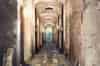 The bays in this side aisle are unused. Each aisle extends beyond the building above. There is a grating in the ceiling at the end of each side aisle that allows some light into the catacombs (Nick Catford)