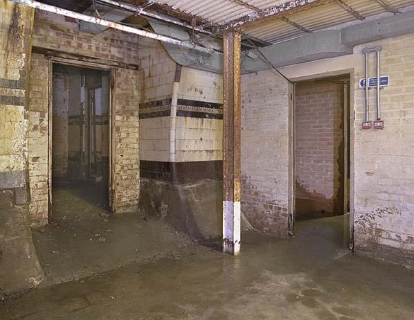 On the lower floor of the shelter on room (left) remains unaltered retaining its original tiling. The door to the right is the corridor along the full length of the shelter (Nick Catford)
