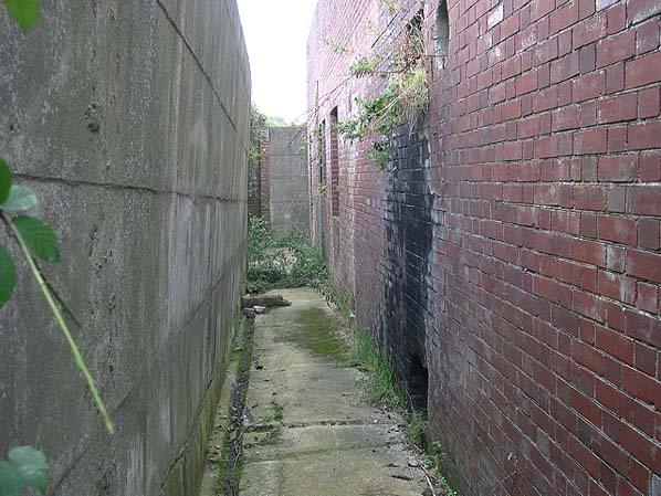 Walkway between the brick receiver block and the blast wall retaining the earth traverse (Nick Catford)