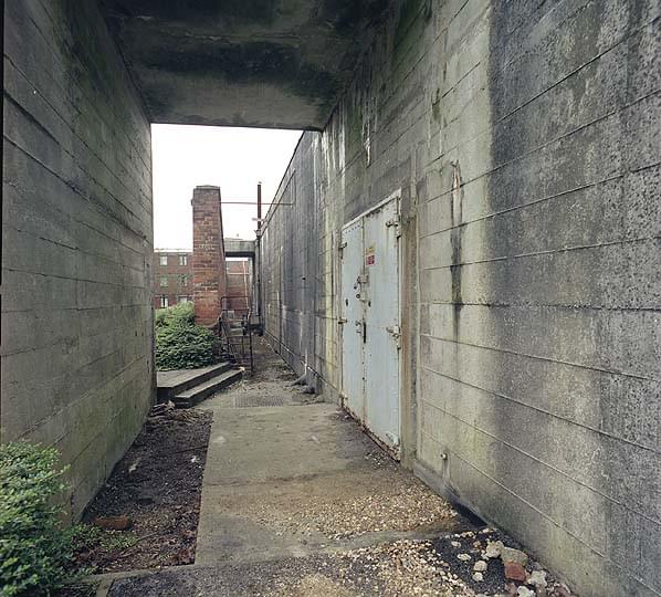 The main entrance to the bunker is protected by a substantial concrete porch. One of two emergency exits, also protected by a porch, can be seen behind the brick kitchen garden wall (Nick Catford)
