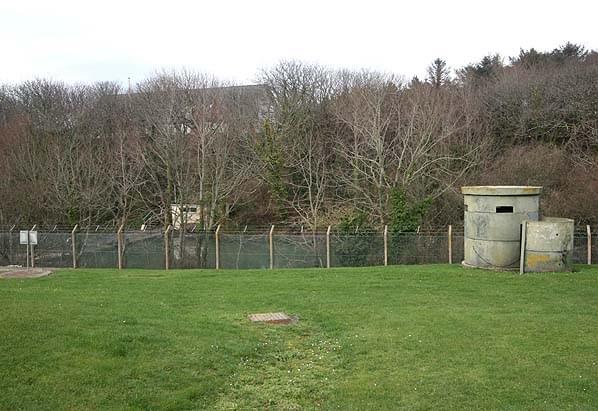 Looking from the reporting post towards the station headquarters which can be seen through the trees. There are a number of Norcon pillboxes within the compound (Nick Catford)