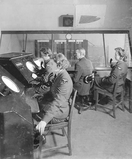 Sopley GCI Final - Chief Controllers room. The console at the left foreground displays IFF Mk.III, the second console is a PPI. This room overlooks the reporting room which can be seen through the windows 