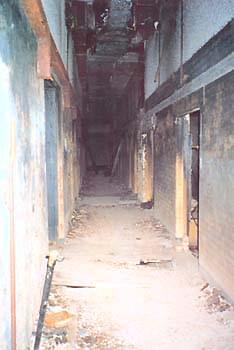 Corridor, with doors to service and rest rooms on the right and stores on the left (Mark Bennett)