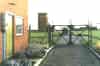 The entrance gate a police house shortly after closure. This view is looking out of the Ace High compound towards the road. The building on the left is the water tower. Behind the right hand gate there is a Nissen hut that housed the WW2 GEE 7000 station and behind that is the chain home transmitter block (Graham Eckersall)