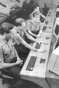 An instructor demonstrates the intricacies of the Intercept Controllers role to students in the Operational Conversion Unit at RAF Ash 
