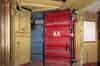 The lift from High Holborn is seen on the left with a blast door on the right into the exchange. The yellow door is the door to the staircase that surrounds the lift shaft. The blue wall behind the two doors is the shaft wall (Nick Catford)