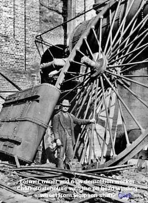 Former miner and now demolition worker Charlie Gatehouse with the put head winding wheel from Simpson shaft 