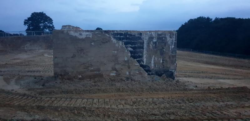 The post once all the surround groundinginh had been removed.  In the images you can see the cable inlet pipe, whats left of the doglegged air vent at the rear of the bunker , a slight bulge at the top where the access shaft was filled in and covered over and the black stuff is the waterproof tanking.   (Jack Watkins)