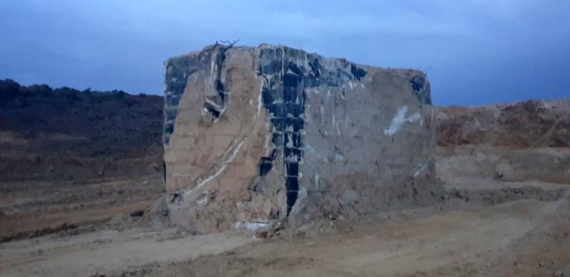 The post once all the surround grounding had been removed.  In the images you can see the cable inlet pipe, whats left of the doglegged air vent at the rear of the bunker , a slight bulge at the top where the access shaft was filled in and covered over and the black stuff is the waterproof tanking.   (Jack Watkins)