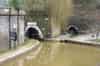 Harecastle Canal Tunnel Portals. The northern portals of the two Harecastle canal tunnels.  On the right is the Brindley tunnel, disused since 1914.  On the left is the still active Telford tunnel; you can see how close the parallel tunnels are to each other. Boat traffic is only admitted under the control of the lock keepers who sequence convoys of up to eight boats alternating in direction.  (Martin Dixon)
