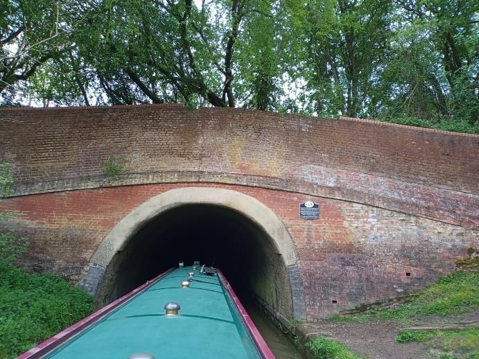 Entering the western portal of Braunston Tunnel; the sign on the right is to commemorate the 200th anniversary of the tunnel. (Linda Dixon)