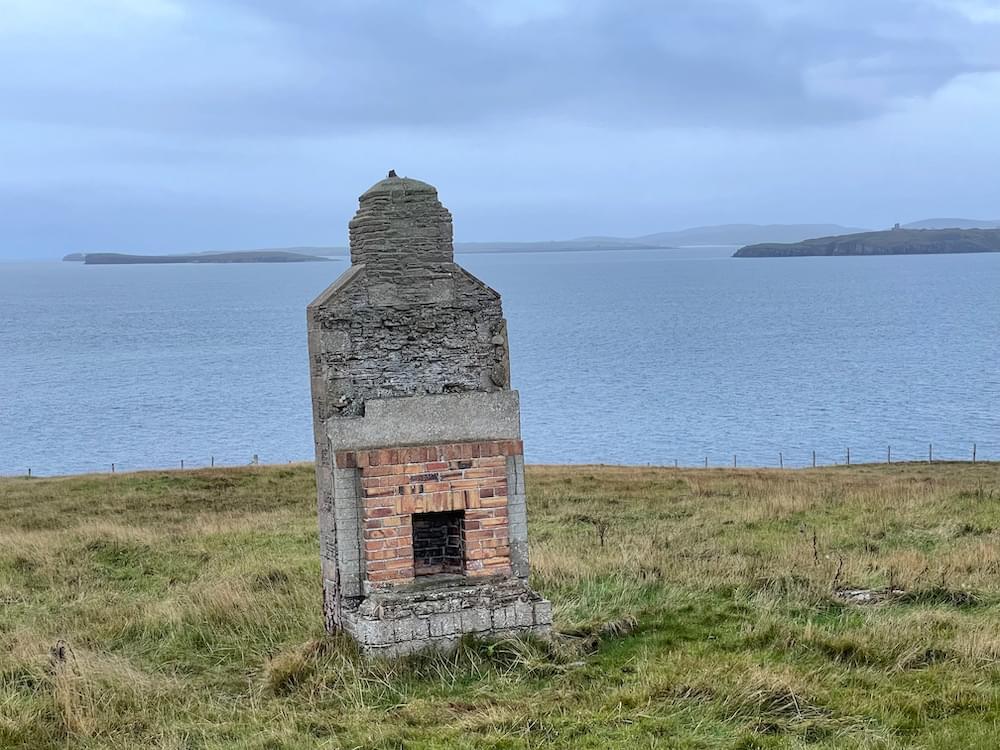 A lonely fireplace looks out over the sea (Neil Iosson - 2021)