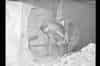 Kingsway Telephone Exchange, Holborn, Tunnel Scheme 2147 construction: base of old west shaft. Drilling through concrete headwall to connect with 7 foot diameter ventilation tube. (1952) (www.digitalarchives.bt.com - TCB 417/E 17664)