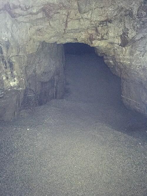 The beach within Piper's Hole Cave, across the underground lake. (Wikimedia Henry Templo)