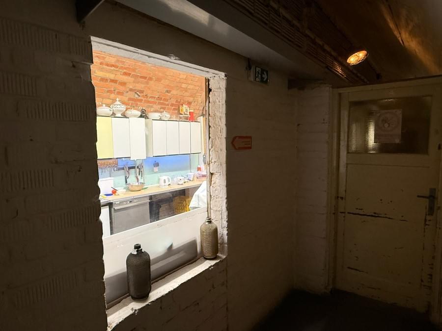 Corridor with partially filled doorway viewing into kitchen area (Neil Iosson - 2025)